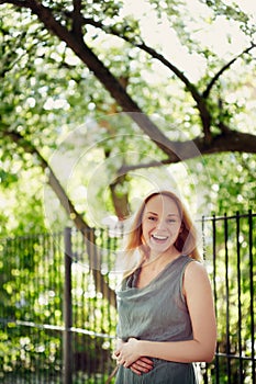 Beautiful laughing young woman in the park. Summer, freedo