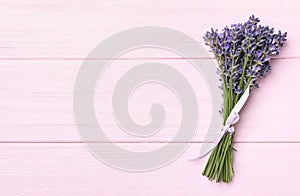 Beautiful lavender bouquet on pink wooden background. Space for text