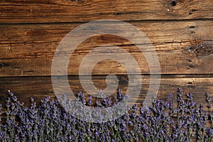 Beautiful lavender flowers on wooden background, flat lay. Space for text