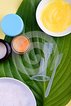 Beautiful layout of cosmetic products on a yellow background. Natural cosmetics for face and body