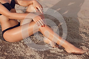 Beautiful Legs On Beach Under Sunshine. Skincare. Protection Sun.