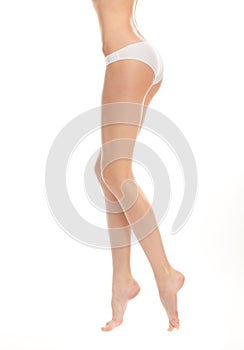 Beautiful legs girl in panties on a white backgrou