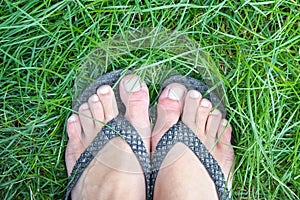Beautiful legs on the grass in the summer park