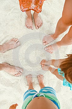 Beautiful legs in the sand of the sea greece background