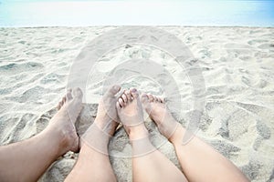 beautiful legs in the sand of the sea greece background