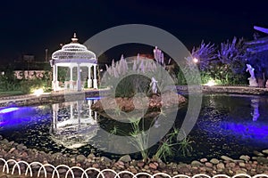 Beautiful leisure park with gazebo and pond with night lighting. North Cyprus landscape