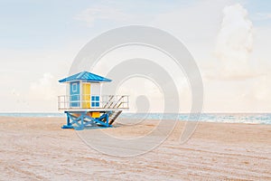 Beautiful light airy tropical Florida landscape with blue yellow lifeguard house. American Florida beach ocean view with lifeguard