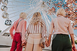 Beautiful light photo of three stylish grannies