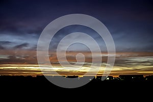 Beautiful light of Sunset with clouds in the sky reflection behind the building