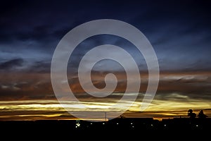 Beautiful light of Sunset with clouds in the sky reflection behind the building