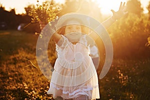 Beautiful lightbeam. Mother with boy and girl spending free time on the field at sunny day time of summer photo