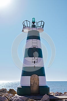 Beautiful lighthouse with calm ocean water background. sunny day outdoors