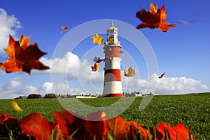 beautiful lighthouse with flying autumn leaves
