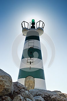 Beautiful lighthouse on sunny day outdoors background. Sunshine sky outside