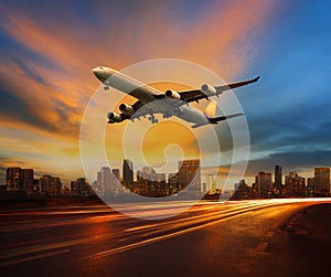 beautiful lighting of vehicle in land transportation and passenger jet plane flying above urban scene use for transport business