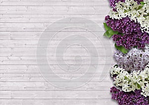 The beautiful lilac on a wooden background