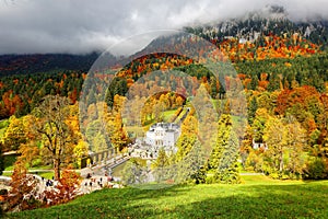 Beautiful Linderhof Palace  Schloss Linderhof  and colorful autumn foliage at the foothills of alpine mountains near Ettal in Ba photo