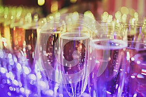 Beautiful line of different colored alcohol cocktails with smoke on a Christmas party, tequila, martini, vodka, and others on part