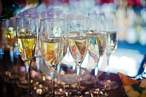 Beautiful line of different colored alcohol cocktails with smoke on a Christmas party, tequila, martini, vodka, and others on part