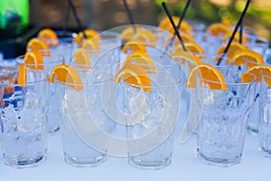 Beautiful line of different colored alcohol cocktails with smoke on a Christmas party, tequila, martini, vodka, and others on part