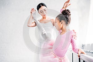 beautiful little african american ballerina training with teacher