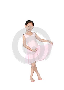 Beautiful little Asian child girl in pink tutu skirt dancing over white background. Children is studying ballet