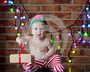 Beautiful little baby boy in elf hat with fairy lights