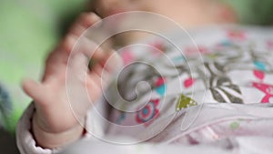 Beautiful little baby girl lying on the bed