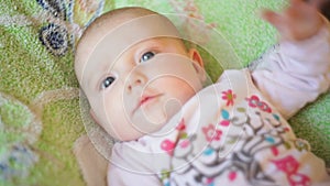 Beautiful little baby girl lying on the bed