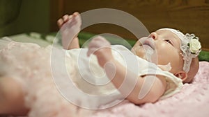 Beautiful little baby girl lying on the bed