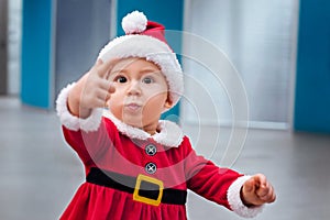 Beautiful little baby in Santa costume