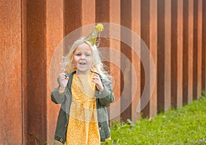 Beautiful little blonde girl celebrates her holiday.