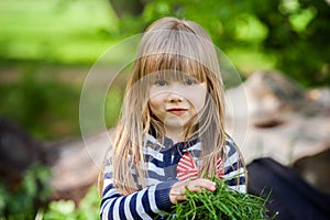 Beautiful little blonde girl, playing outdoor, springtime