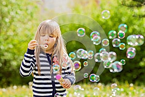 Beautiful little blonde girl, playing outdoor, springtime