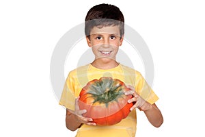 Beautiful little boy with a big pumpkin