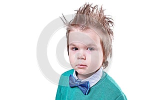 Beautiful little boy in blue bow tie and green sweater, isolated on white background