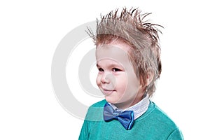 Beautiful little boy in blue bow tie and a green sweater, smiling isolated on white background