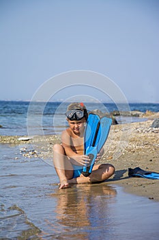 Beautiful little boy with diving gear ready to dive