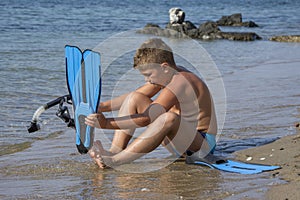 Beautiful little boy with diving gear ready to dive