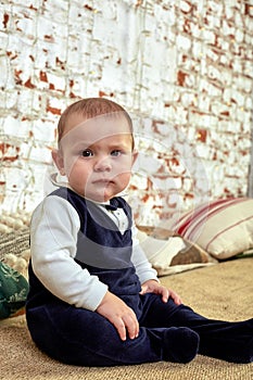 Beautiful little boy dreaming of cottages under the Christmas tree. Christmas concept and children waiting for a miracle