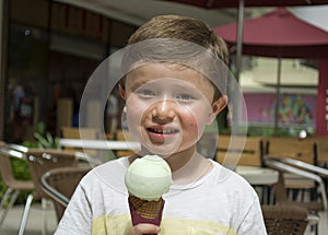 Beautiful little boy eating ice cream.