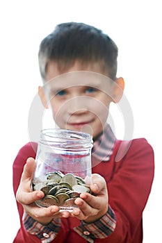 Beautiful little boy with glass jar of coins isolated
