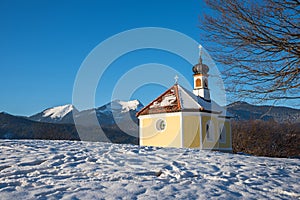 Beautiful little chapel near spa town Kruen, at christmas season with view to mountains