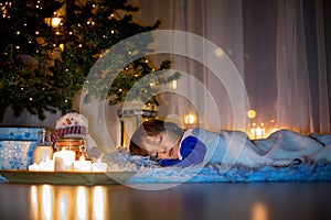 Beautiful little child, boy, lying down on the floor,sleeping un