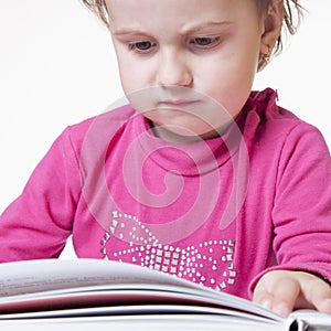 Beautiful little child girl learns to read success, education,