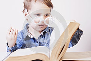 Beautiful little child girl learns to read success, education,