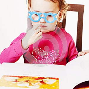 Beautiful little child girl learns to read success, education,