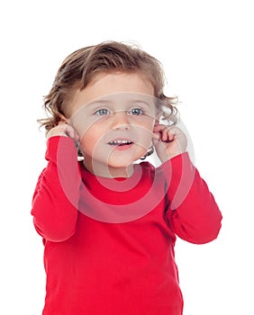 Beautiful little child two years old touching his ears photo