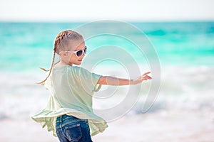 Beautiful little girl at beach having fun. Funny girl enjoy summer vacation.