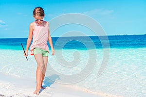 Beautiful little girl at beach having fun. Funny girl enjoy summer vacation.